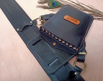 May include: Black leather quiver with a brown leather label that says "Horse Craft". The quiver is attached to a black leather belt with a brass buckle.