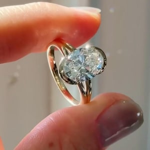 Bezel Set Oval Moissanite Engagement Ring: Split Shank, 1.65 Ct