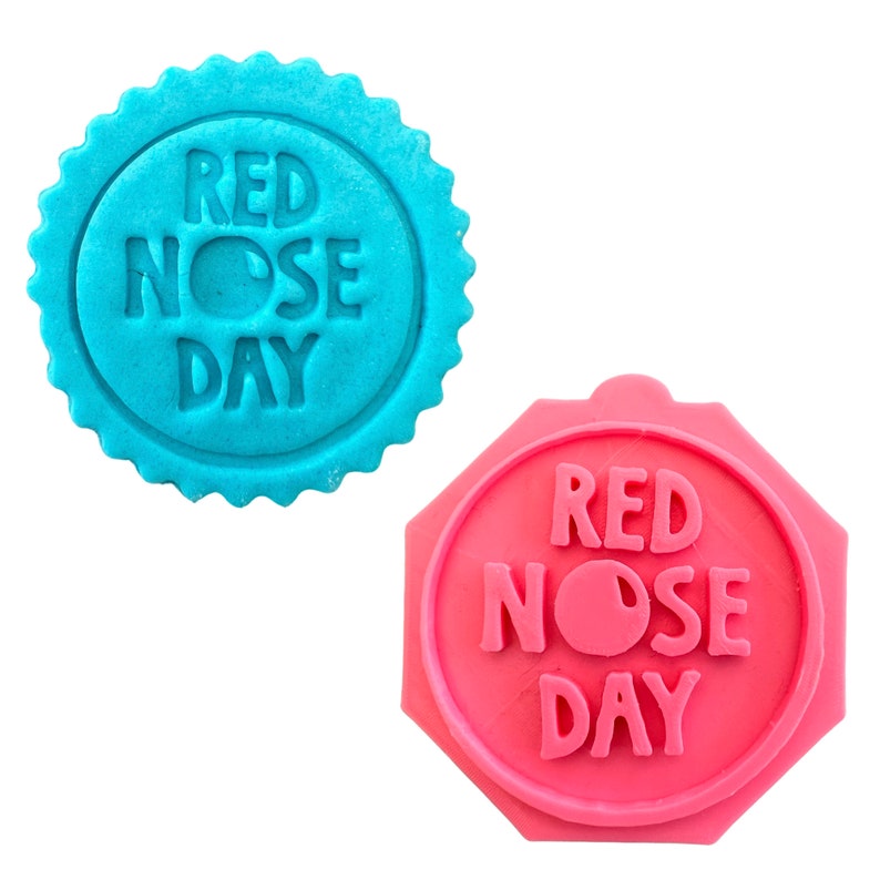 May include: Two red nose day cookie cutters, one blue and one pink. The blue cutter is round with a scalloped edge. The pink cutter is an octagon shape. Both cutters have the text "RED NOSE DAY" with a red nose in the middle.
