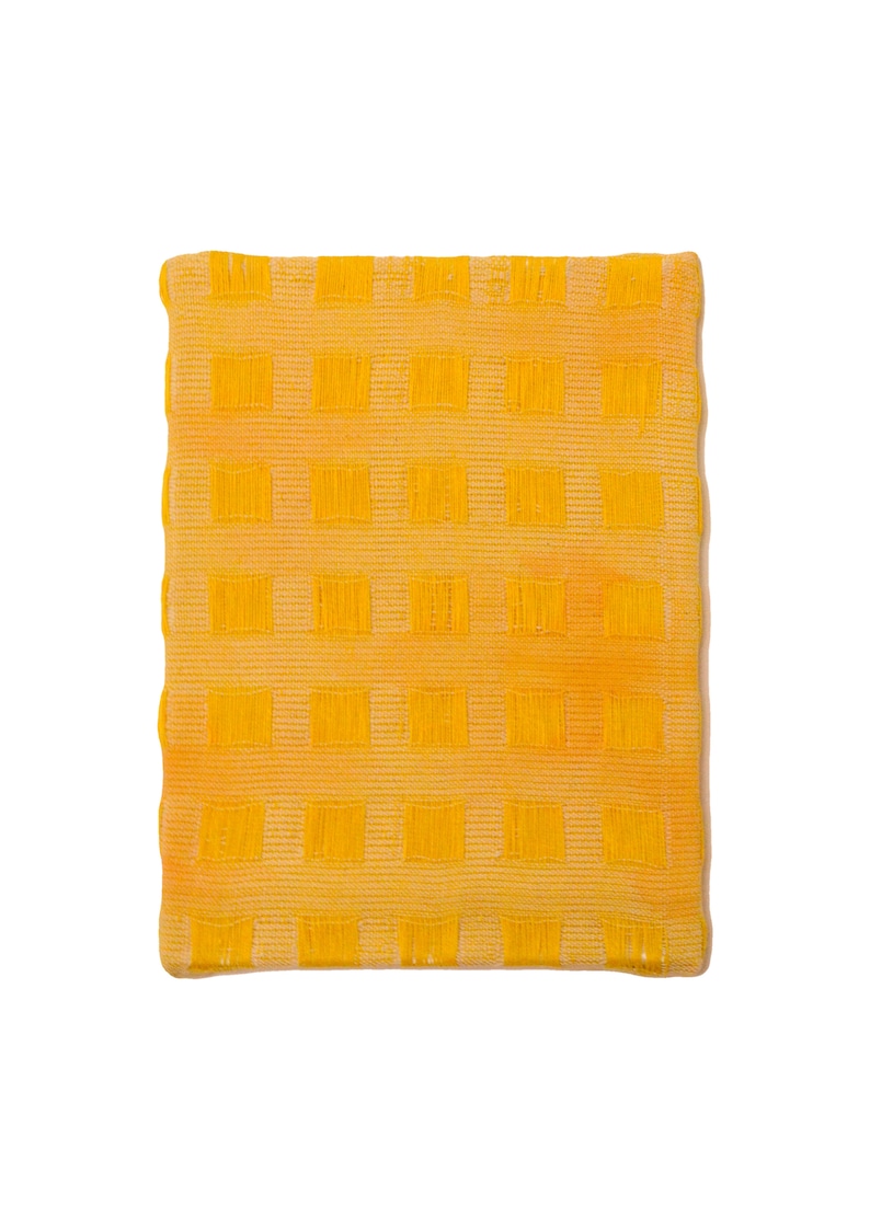 May include: A yellow kitchen towel with a checkered pattern.