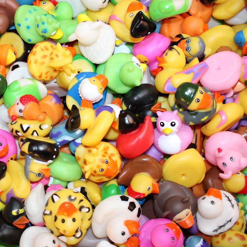 May include: A large collection of colorful rubber duck toys in various shapes and sizes. The ducks are made of soft, flexible rubber and feature a variety of designs, including animals, cartoon characters, and abstract patterns.