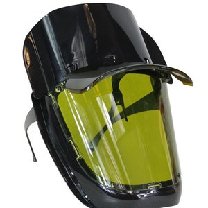 May include: Black safety glasses with a yellow tinted visor and a black headband.