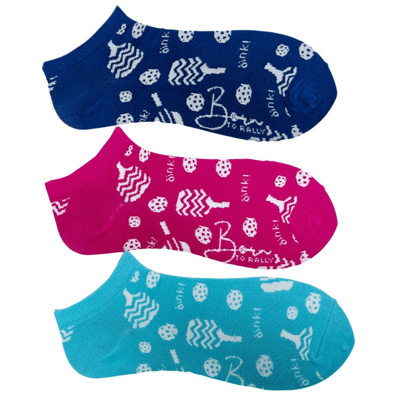 May include: Three pairs of no-show socks in blue, fuchsia, and turquoise. Each sock features a white pattern of pickleball paddles, balls, and the text "dink!" and "Born to Rally".