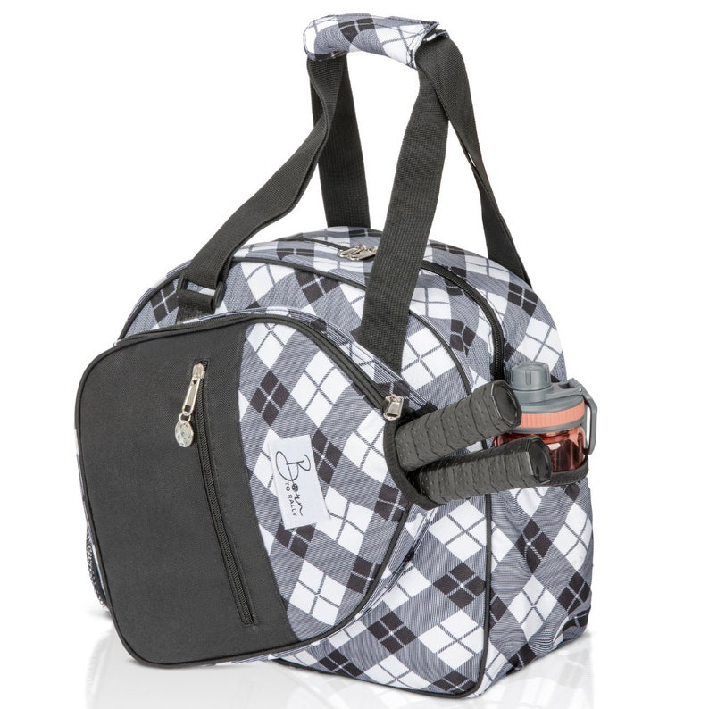 May include: Black and white checked sports bag with a black zipped pocket and a black handle. The bag has a side pocket with a water bottle and a racket.