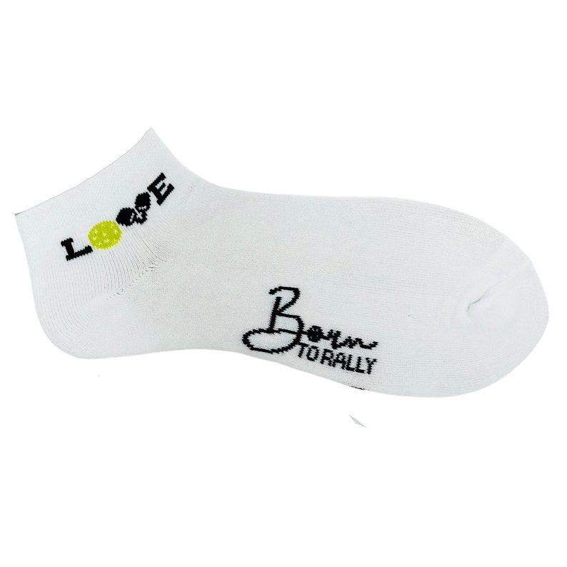 May include: White ankle sock with the word "LOVE" in black letters and a yellow pickleball graphic. The phrase "Born to Rally" is written in black script on the sock.
