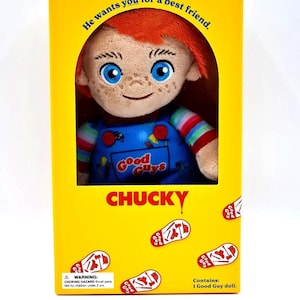 May include: A Chucky doll in a yellow box. The doll has red hair, blue eyes, and freckles. The box reads "He wants you for a best friend" and "CHUCKY". The doll is wearing blue overalls.