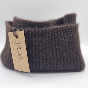 May include: A brown ribbed knit headband with a brown paper tag that says "PlantMix with natural wool fibres".
