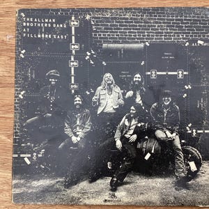 May include: A rustic wooden sign with the text "Welcome to our home" in white lettering. The sign features a distressed finish and a simple, inviting design, perfect for a front porch or entryway.