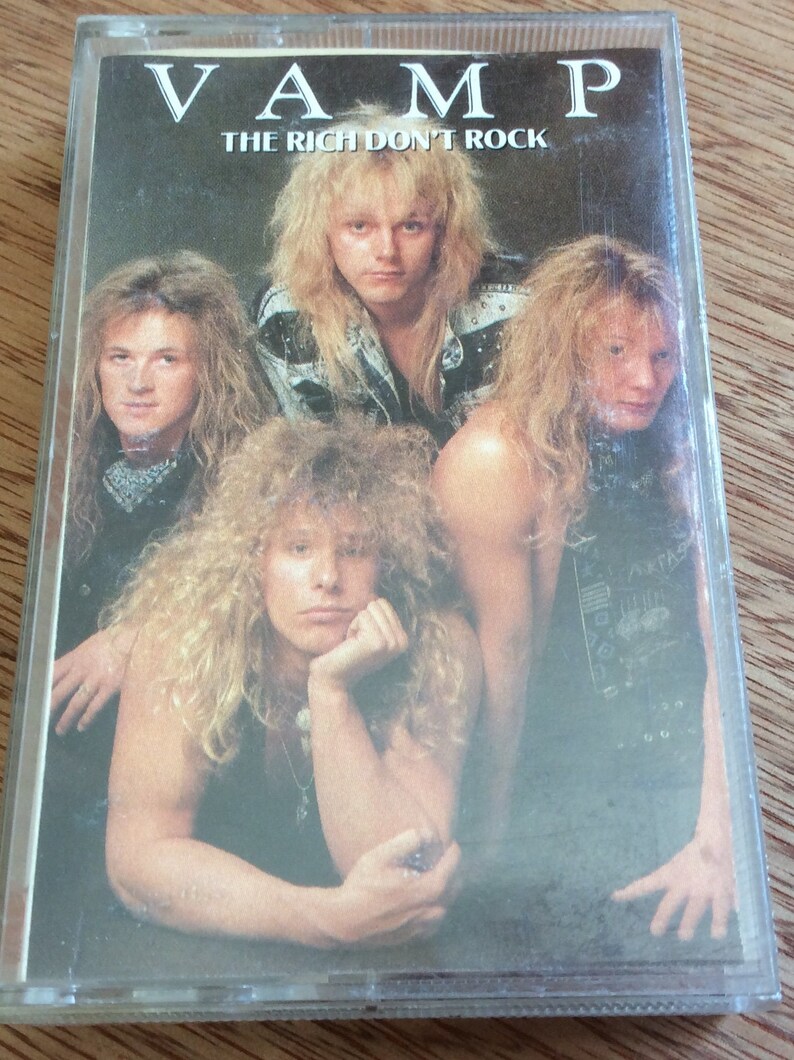 May include: A cassette tape featuring a band photo of four men with long hair. The band is called "VAMP" and the album title is "THE RICH DON'T ROCK".
