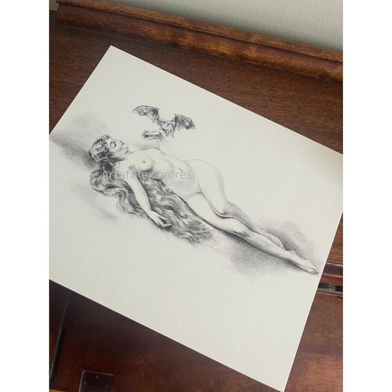 May include: A monochrome pencil drawing of a nude figure with long hair, lying down. A bat-like creature is depicted above the figure. The text "Arts of Alexandre" is visible.