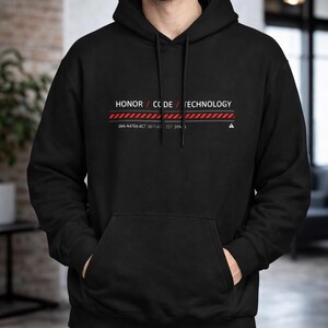 May include: Black hoodie with a front pocket and drawstring hood. The hoodie features the text "HONOR / CODE / TECHNOLOGY" in white, with a red and white striped line underneath. Below the line is the text "094-A476X-ACT INITIAT EST SYN".