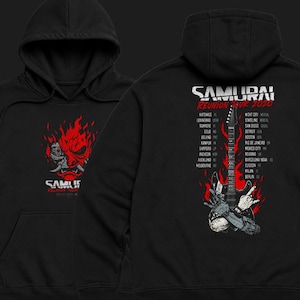 May include: A black hooded sweatshirt featuring a red and white graphic of a robotic oni mask on the front. The back displays a red flame design, a black electric guitar, a robotic hand making a rock gesture, and the text SAMURAI REUNION TOUR 2020.
