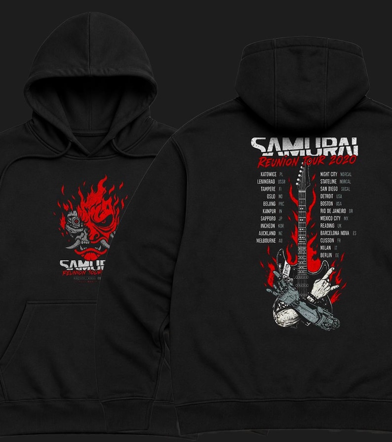 May include: A black hooded sweatshirt featuring a red and white graphic of a robotic oni mask on the front. The back displays a red flame design, a black electric guitar, a robotic hand making a rock gesture, and the text SAMURAI REUNION TOUR 2020.