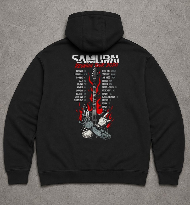 May include: A black hooded sweatshirt featuring a graphic on the back with the text SAMURAI REUNION TOUR 2020. The design includes a central electric guitar surrounded by red flames and a robotic hand, flanked by two columns of city names.