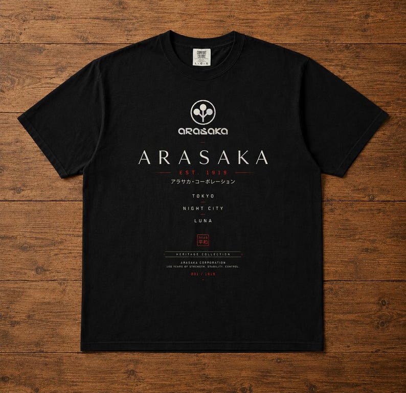 May include: A black short-sleeve t-shirt featuring a white Arasaka logo and text. The graphic includes the words ARASAKA, EST. 1919, TOKYO, NIGHT CITY, LUNA, and HERITAGE COLLECTION, along with Japanese characters and a small red square emblem.