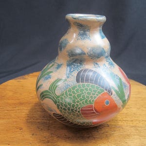 May include: A hand-painted ceramic vase with a gourd shape and a blue, green, red, and black fish design.