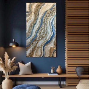 May include: Abstract wall art featuring a flowing design with gold, white, and blue accents. The artwork has a textured appearance, resembling a river or geological formation. The piece is displayed in a modern interior setting.