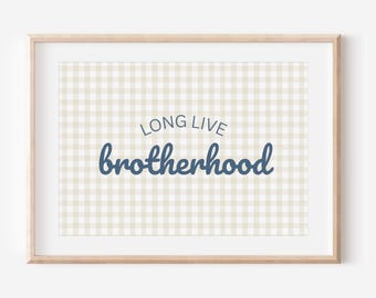 May include: A framed print with a light wood frame. The background is a beige and white gingham pattern. The words "LONG LIVE" are above the word "brotherhood" in a dark blue script font.