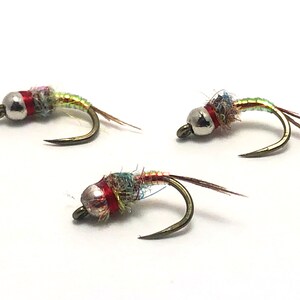 May include: Three fly fishing lures with silver beads, red thread, and iridescent green and brown feathers.