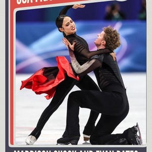 May include: A trading card-style image featuring USA figure skaters Maddison Chock and Evan Bates in a performance pose. The skaters are dressed in black outfits, with Chock's costume accented by a red skirt. The card includes the text "USA FIGURE SKATING".