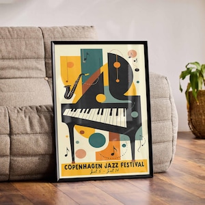 May include: A black framed poster with a colorful abstract design featuring a piano, musical notes, and the text "Copenhagen Jazz Festival Jul 5 - Jul 14".