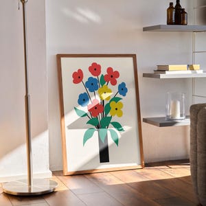 May include: A framed print of a colorful floral bouquet with red, blue, yellow, and green flowers in a black vase. The print is on a white background and has a wooden frame.