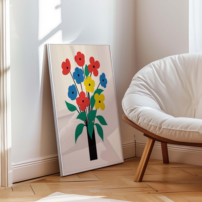 May include: A framed print of a colorful bouquet of flowers in a vase. The flowers are red, blue, and yellow. The vase is black and the background is white.