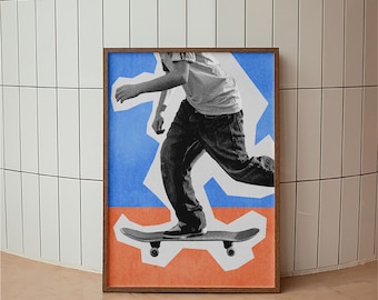 May include: A framed art print featuring a collage-style image of a person skateboarding. The artwork has a brown wooden frame and a background with blue, orange, and white geometric shapes. The skater is wearing a t-shirt and jeans.