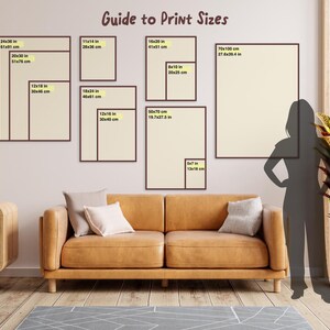 May include: A guide to print sizes with different frame sizes shown on a wall. The sizes are listed in inches and centimeters. The largest frame is 70 inches by 100 centimeters.