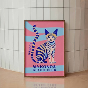 May include: A pink and blue illustrated poster with a stylized cat design. The poster features the text "Greece" and "Mykonos Beach Club".