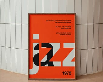 May include: A rectangular framed poster with a vibrant orange background featuring the word jazz in large white and black letters. The text reads: die deutsche jazz föderation präsentiert das deutsche jazzfestival, 24. märz - 26. märz 1972, 14:00 - 20:00 uhr, jahrhunderthalle höchst frankfurt am main, 1972.