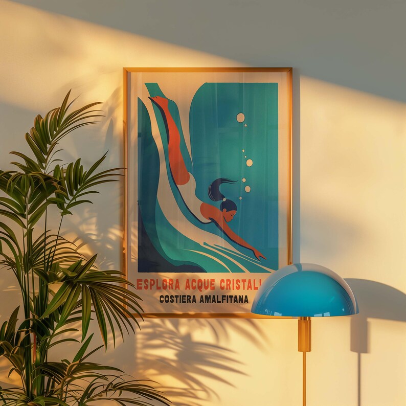 May include: A vintage-style poster with a woman diving into a blue wave. The poster is framed in wood and has the text "Esplora Acque Cristalli Costiera Amalfitana".