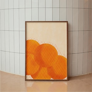 May include: Abstract art print in a wooden frame. The artwork features overlapping orange circles with a grid pattern over them, set against a beige background. The frame is a dark brown color. The print is displayed on a light pink surface.