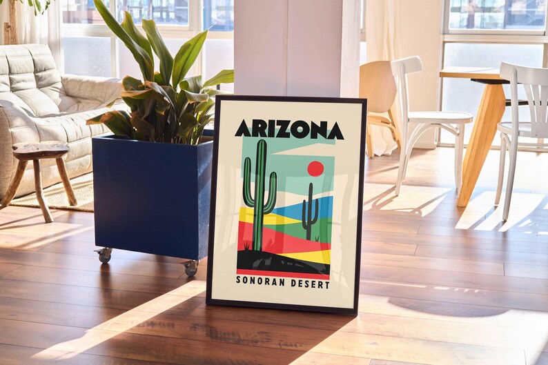 Może przedstawiać: Czarny plakat w ramie z kolorową ilustracją pustynnego krajobrazu z dwoma kaktusami i tekstem "Arizona Sonoran Desert".