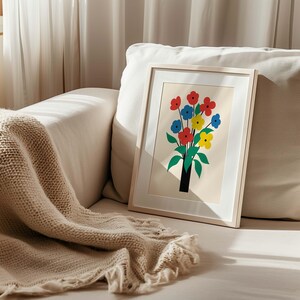 May include: A framed print of a colorful bouquet of flowers in a vase. The flowers are red, yellow, blue, and green. The print is on a white background and has a simple, modern style.