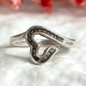 May include: A set of three ceramic mugs with a speckled, matte finish. The mugs are in shades of cream, light gray, and dark gray. Each mug has a simple, modern design and a rounded handle. Perfect for coffee or tea.