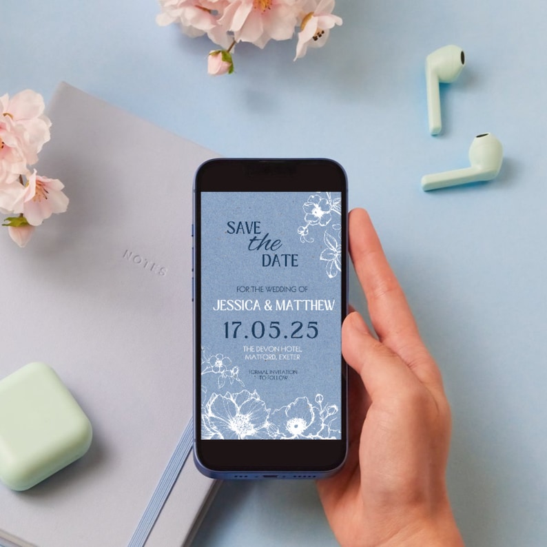 May include: A blue save the date card with white floral designs and the text "Save the Date" for the wedding of Jessica & Matthew on 17.05.25 at The Devon Hotel, Matford Exeter.  The card also includes the text "Formal Invitation to Follow."
