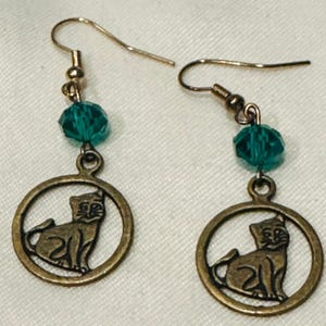 Earrings featuring a cat charm and a blue bead Women’s dangle