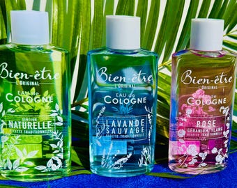May include: Three glass cologne bottles with white caps. The bottles are filled with green, blue, and pink liquids. Each bottle has a label with the words "Bien-être L'Original Eau de Cologne". The labels also include the scent names: "Naturelle", "Lavande Sauvage", and "Rose".