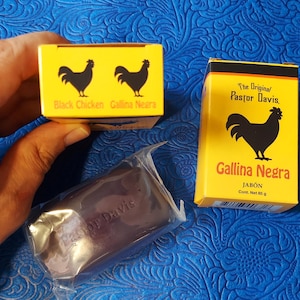 May include: Two yellow boxes with black rooster graphics and text in Spanish and English. One box reads "Black Chicken Gallina Negra". A bar of soap in a clear wrapper is also visible. The soap box reads "Gallina Negra".