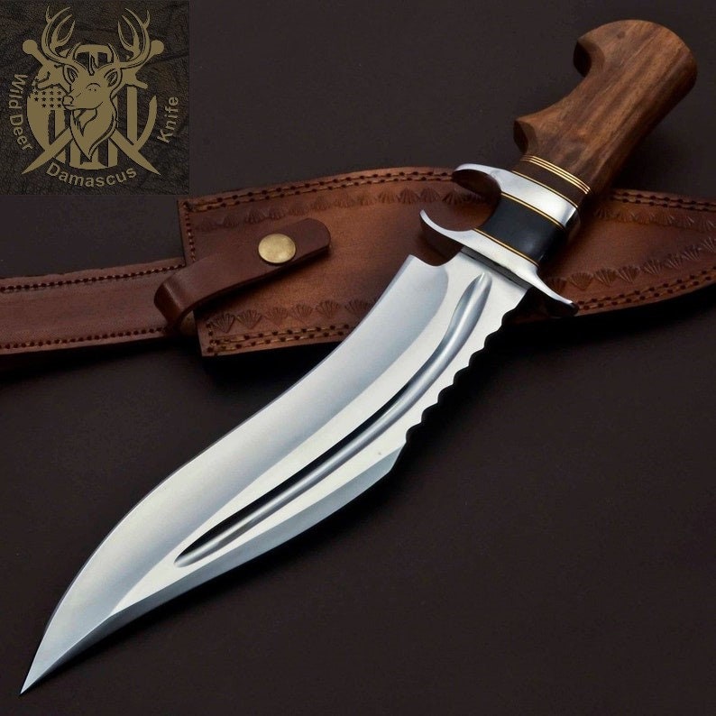 May include: A large, silver, serrated knife with a brown wooden handle. The knife is in a brown leather sheath with a brass button.