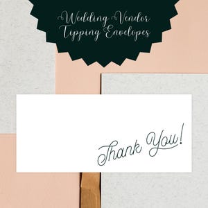 May include: White card with the text "Thank You!" written in black cursive script. The card is on a light pink and gray textured background.