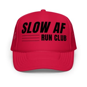 May include: A bright red trucker hat with a curved brim and mesh back. The hat features the text "SLOW AF RUN CLUB" in bold black letters across the front, with three horizontal lines underneath.