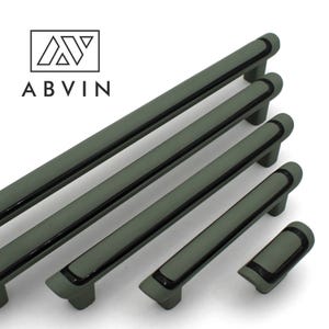 May include: Five different sizes of green cabinet pulls with black trim. The pulls are made of metal and have a modern design.