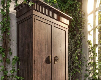 May include: A dark brown wooden cabinet with two doors and brass handles. The cabinet has a decorative top and is surrounded by green vines and plants. The cabinet is in a room with a window.