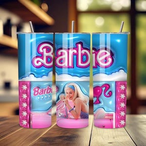 May include: A tumbler featuring a Barbie theme. The design includes the word "Barbie" in pink and white, a picture of a woman, and pink and blue accents. The tumbler has a silver straw and a lid.