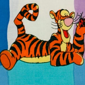 May include: A vibrant illustration of Tigger from Winnie the Pooh. Tigger, in orange with black stripes, has a pink nose and yellow mouth, holding a ladybug. The background is a patchwork of blue, white, and purple.