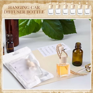 May include: A collection of hanging car diffuser bottles with wooden tops and clear glass containers. The bottles are filled with a yellow liquid. The image includes a small brown bottle and a dropper. The text "HANGING CAR DIFFUSER BOTTLE" is at the top.