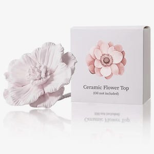 May include: A light pink ceramic flower top with detailed petals, next to a white box featuring a similar flower design. The box text reads "Ceramic Flower Top (Oil not included)". The flower is a decorative item.