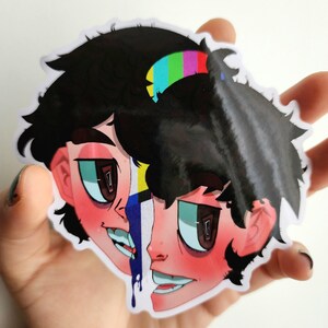 May include: A sticker featuring a split-face illustration with black hair and a glitch effect. One side of the face has a distorted rainbow pattern, while the other side is intact. The sticker has a glossy finish.
